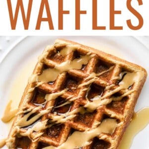An overhead and close up photo looking at a plate with a rectangular protein waffle that has been drizzled with maple syrup and peanut butter.