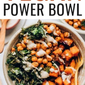 A vegan power bowl drizzled with creamy white bean dressing. A gold fork rests in the bowl.