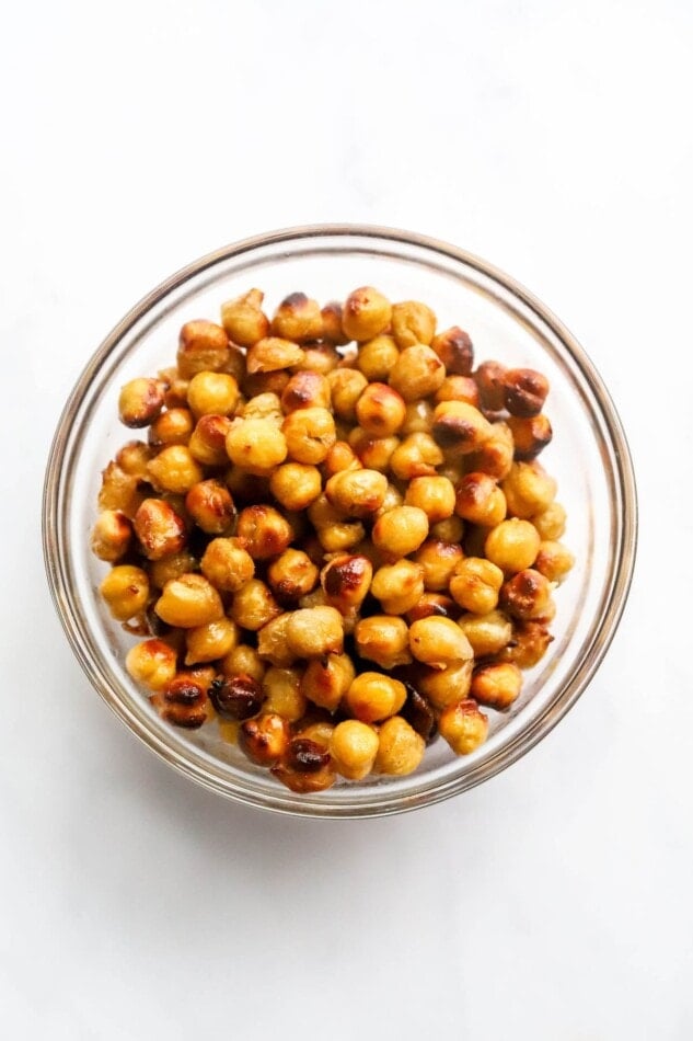 Air fried honey chickpeas in a glass bowl.