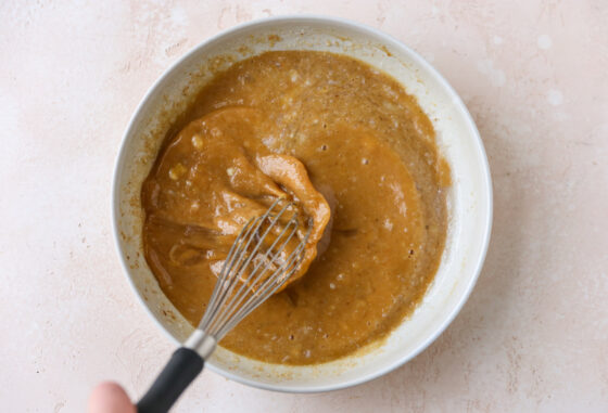 Wet and dry ingredients incorporated together with a whisk.