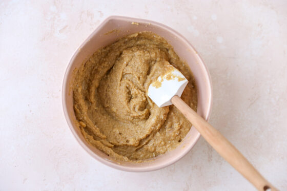 Cupcake batter in a mixing bowl. A spatula rests in the bowl.