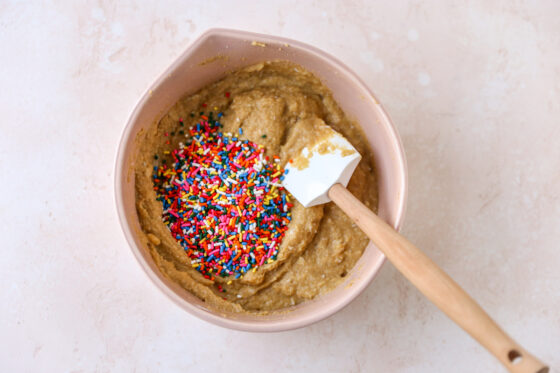 Rainbow sprinkles added to the cupcake batter.