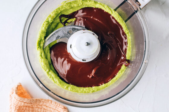 Melted chocolate poured into the pureed avocado in a food processor.