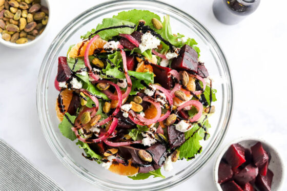 Ingredients for baby beet and clementine salad layered in a serving bowl.