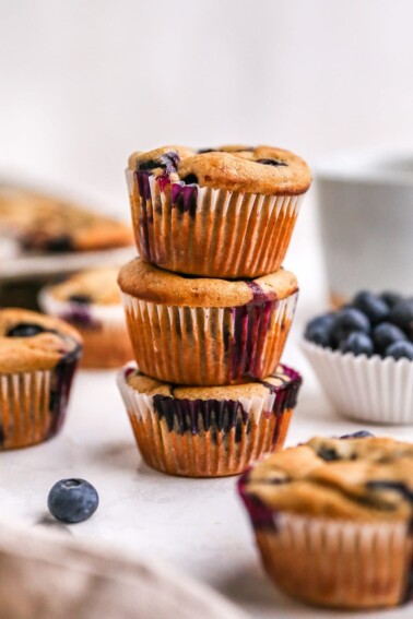 Three blueberry yogurt muffins stacked.