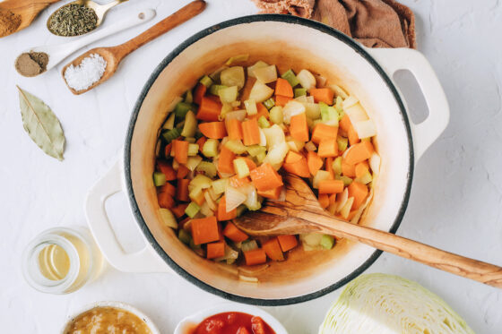 Onion, carrots and celery sautéing in a large pot.