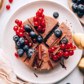 An overhead photo of a vegan chocolate tart. It has been sliced into 4 quarters.