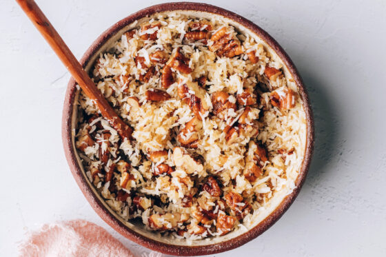 Melted butter, brown sugar, pecans, and coconut milk combined in a small mixing bowl.