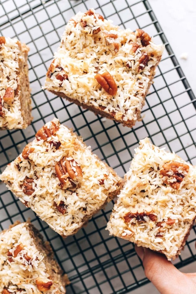 An overhead photo of 3 squares of oatmeal cake on a wire cooling rack.