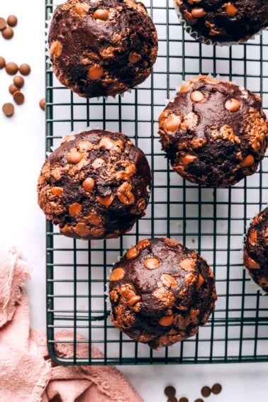 A birds eye view of 4 chocolate chip muffins on a wire rack.