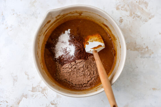 Protein powder, cocoa powder, sea salt and baking powder added to the mixing bowl.