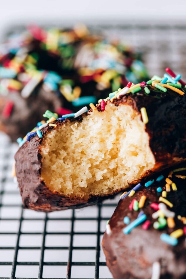 Closeup of a protein donut with a bite taken out of it, exposing the inside.