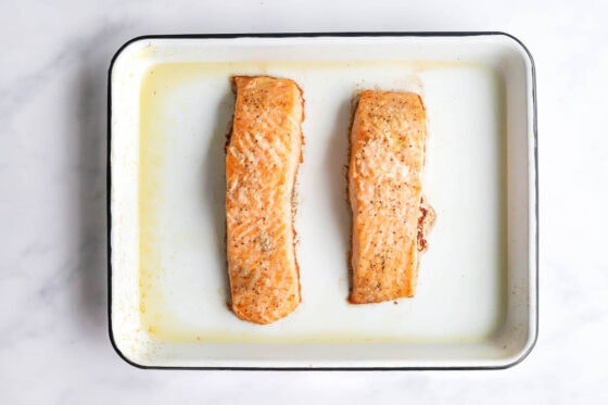 Baked salmon filets in a baking dish.