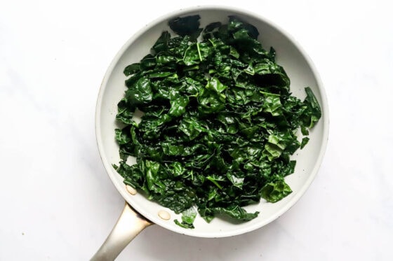 Sautéed kale in a sauté pan.