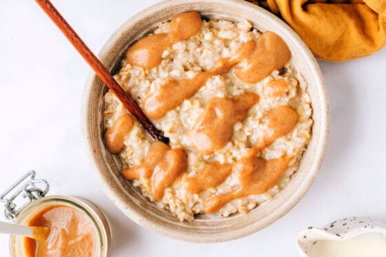 Date caramel sauce drizzled on top of creamy oatmeal.