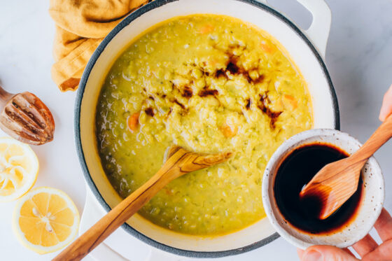 Tamari and lemon juice added to large pot containing split pea soup.