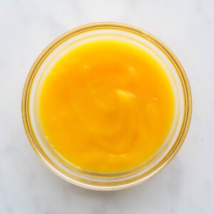 A small glass bowl containing mango puree.