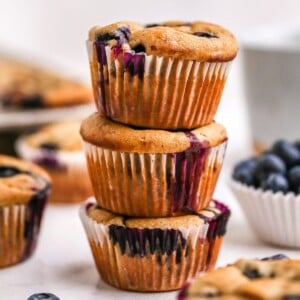 Three blueberry yogurt muffins stacked.