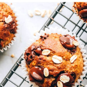 An overhead photo looking at an oatmeal banana muffin on a wire cooling rack.