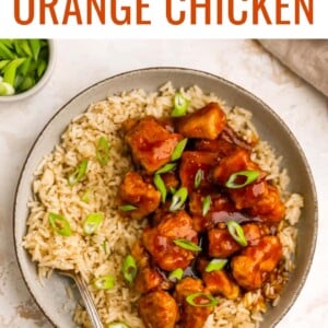 An overhead photo of healthy orange chicken served over a bed of rice.