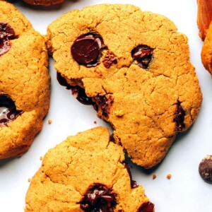 Chocolate chip peanut butter protein cookie broken in half.