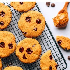Chocolate chip protein cookies on a wire cooling rack.