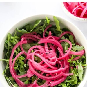 Salad topped with pickled red onions.