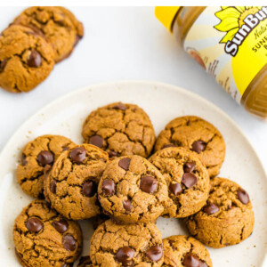 Plate of chocolate chip sunbutter cookies. A jar of SunButter is in the background.