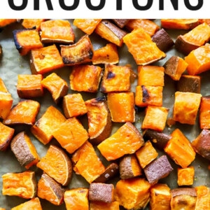 Roasted sweet potato croutons on a sheet pan.