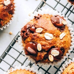 An overhead photo looking at an oatmeal banana muffin on a wire cooling rack.