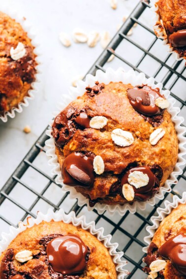 An overhead photo looking at an oatmeal banana muffin on a wire cooling rack.