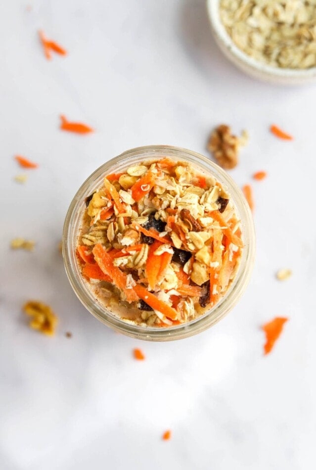 Overhead view of carrot cake overnight oats ingredients in a jar.