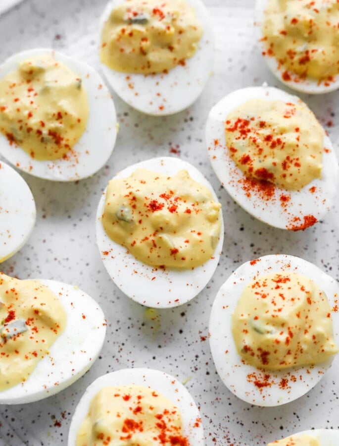 A close up of healthy deviled eggs sprinkled with paprika.