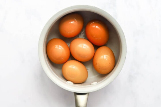 Eggs in a saucepan, covered with water.