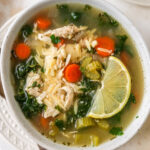 A bowl of lemon chicken orzo soup.