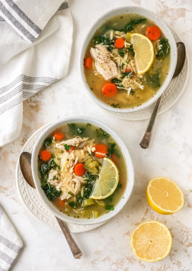 Two bowls of lemon chicken orzo soup.