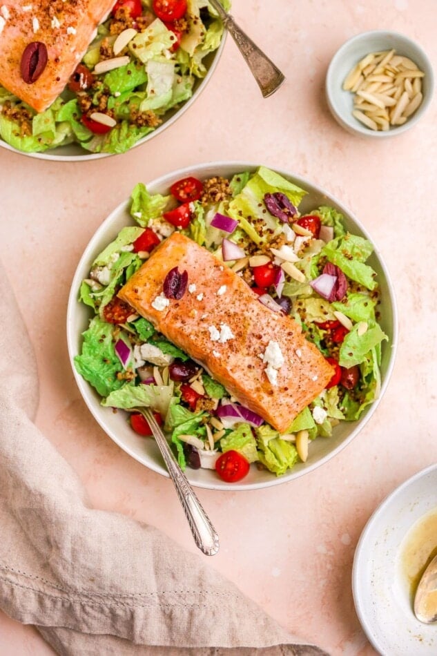 A salad bowl with mediterranean salmon salad.