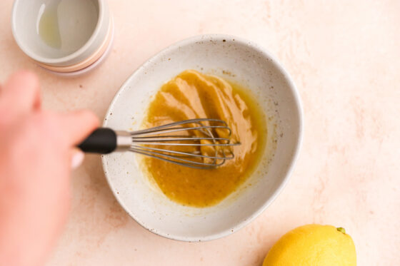 Whisking together ingredients for dressing.