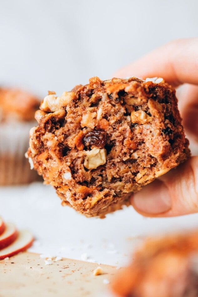 A morning glory muffin with a bite taken out of it.