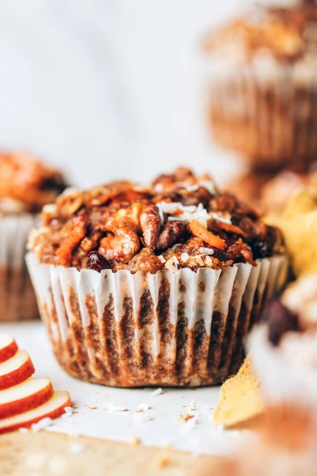 A morning glory muffin wrapped in a paper liner.