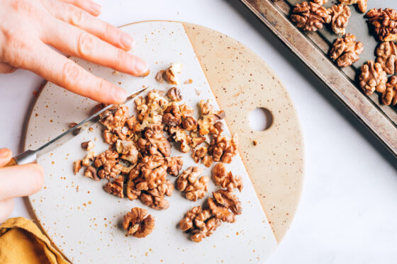 Chopping toasted walnuts.