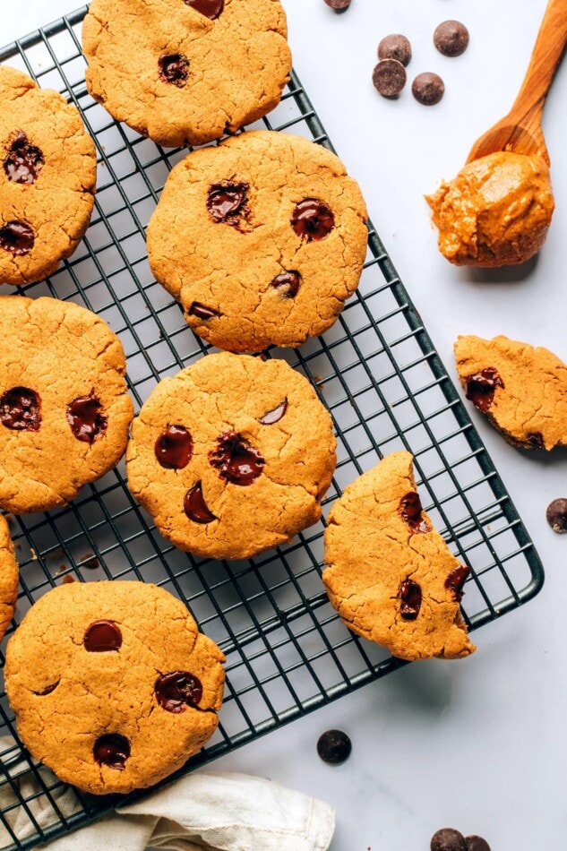Chocolate chip protein cookies on a wire cooling rack.