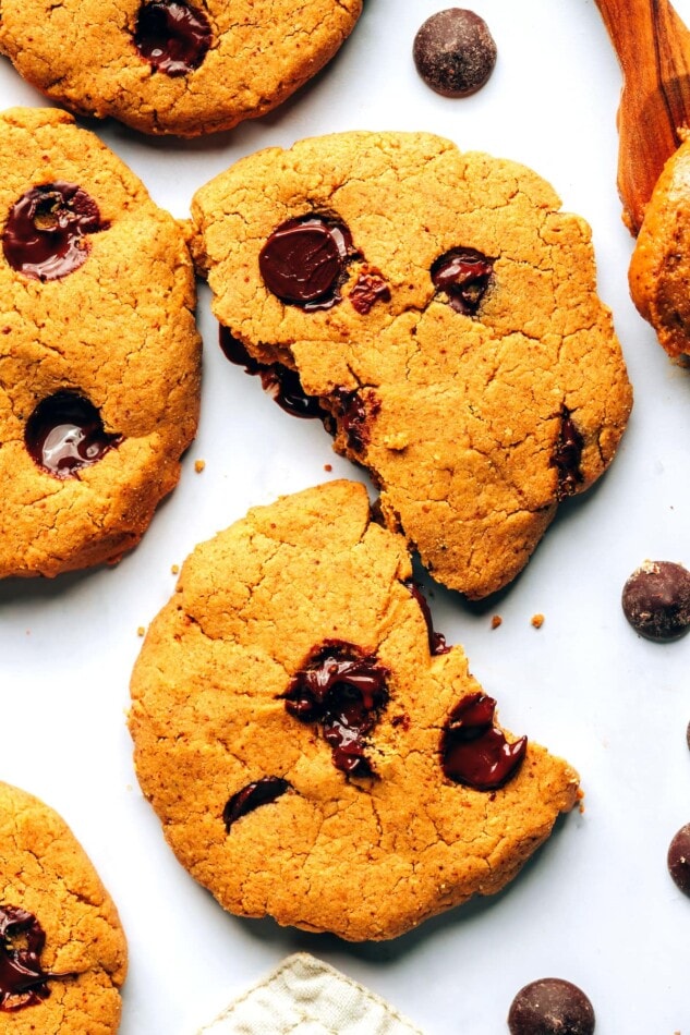 A close up photo of two halves of a protein cookie on a table top.