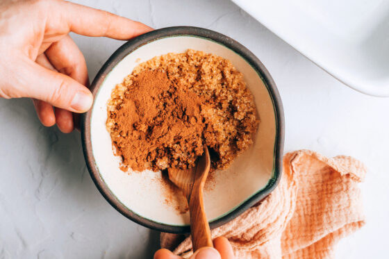 Mixing together brown sugar and cinnamon together in a bowl.