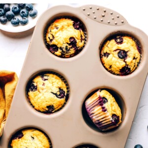 A 6-muffin tin with 6 baked muffins.