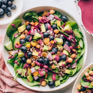 An overhead photo looking down at a bowl of spinach blueberry salad.