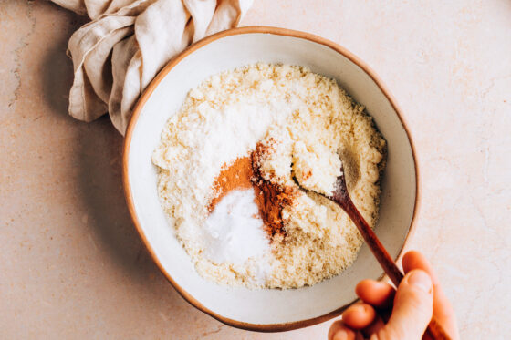 Almond flour, coconut flour, cinnamon and baking soda mixed together in a bowl.