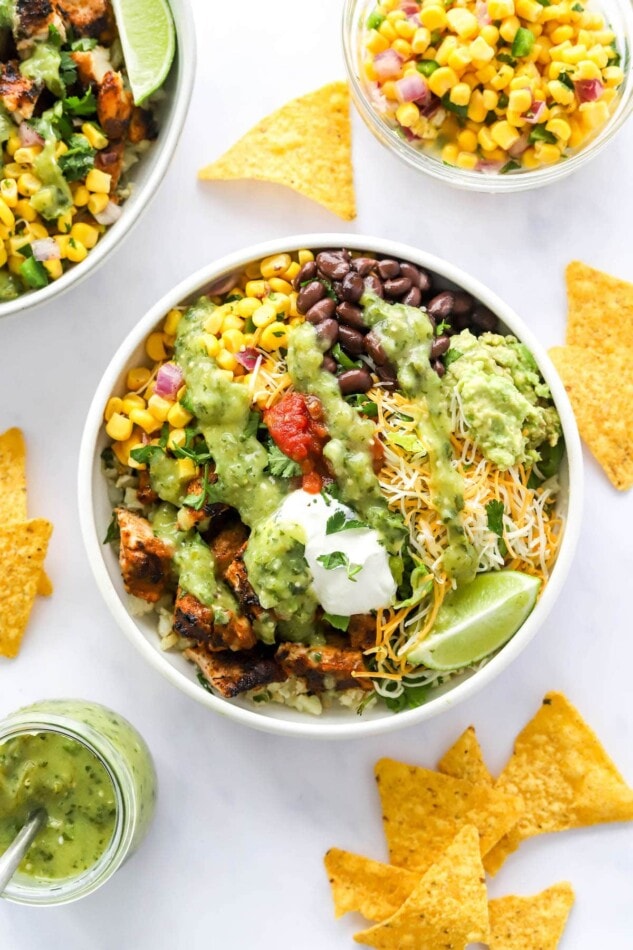 A chicken burrito bowl drizzled with tomatillo avocado dressing.