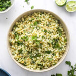 Looking down at a serving bowl containing cilantro lime cauliflower rice.