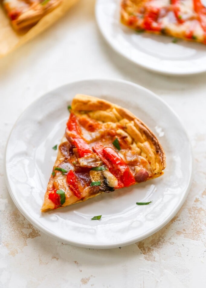 A slice of cloud bread pizza on a white plate.